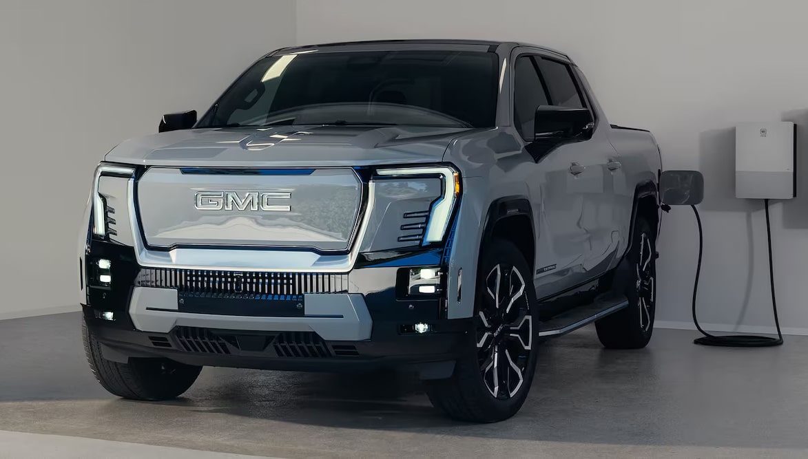Electric GMC truck in a modern charging station, showcasing sleek design and innovative technology.