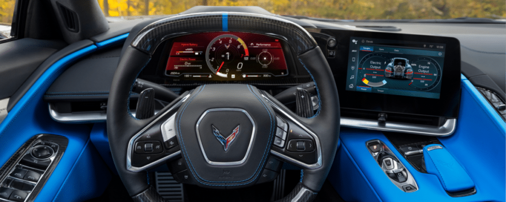 Luxury sports car interior with a sleek steering wheel, digital dashboard, and vibrant blue accents.